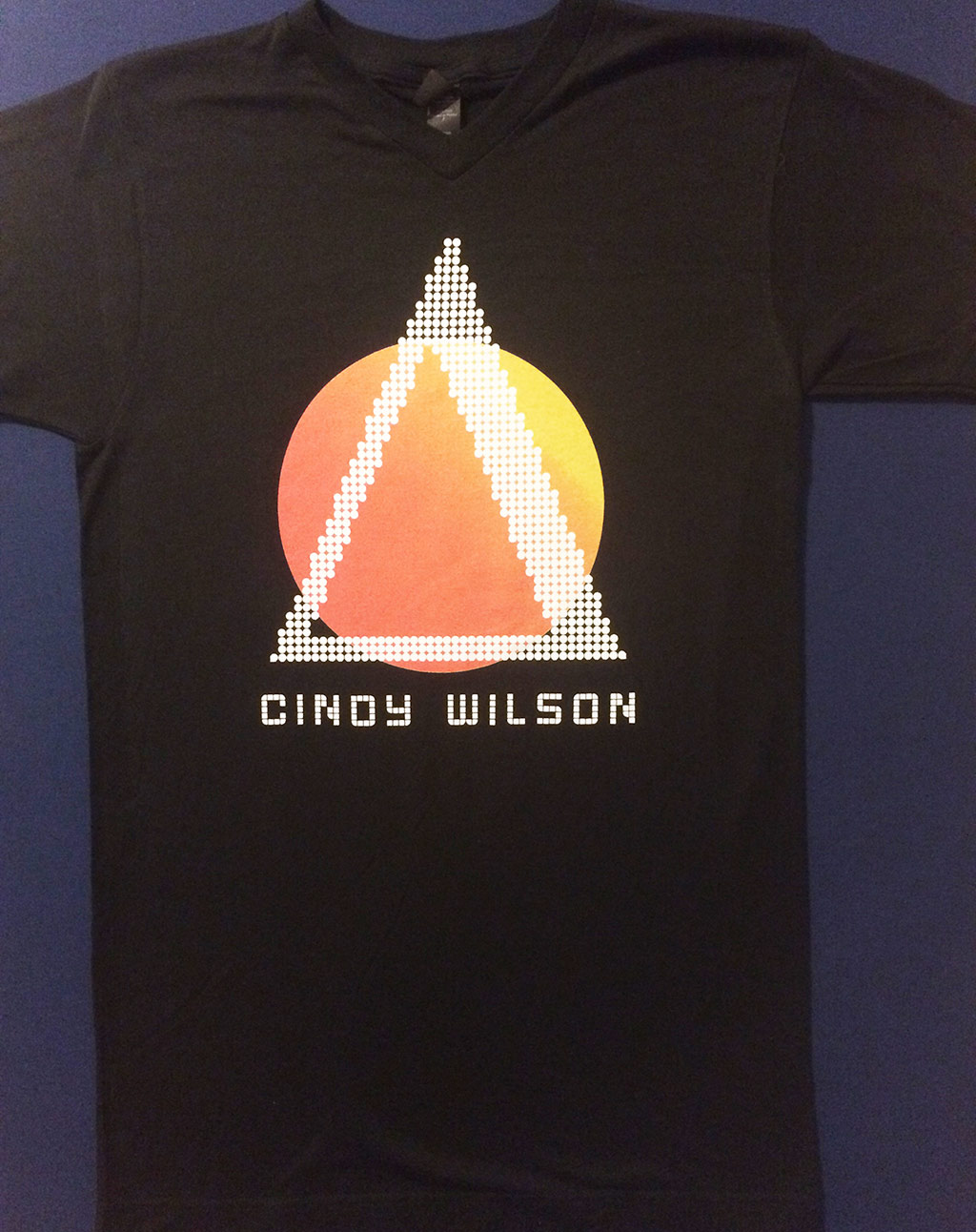 Limited edition Cindy Wilson "Sunrise" black unisex v-neck t-shirt featuring art by Suny Lyons.